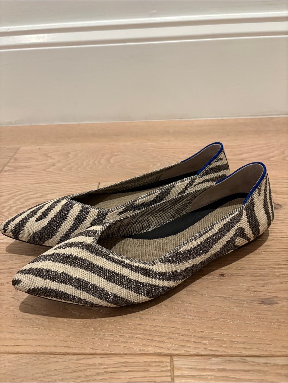 Rothy's Zebra-Print Point II Flats in gray-black & cream with signature blue tri